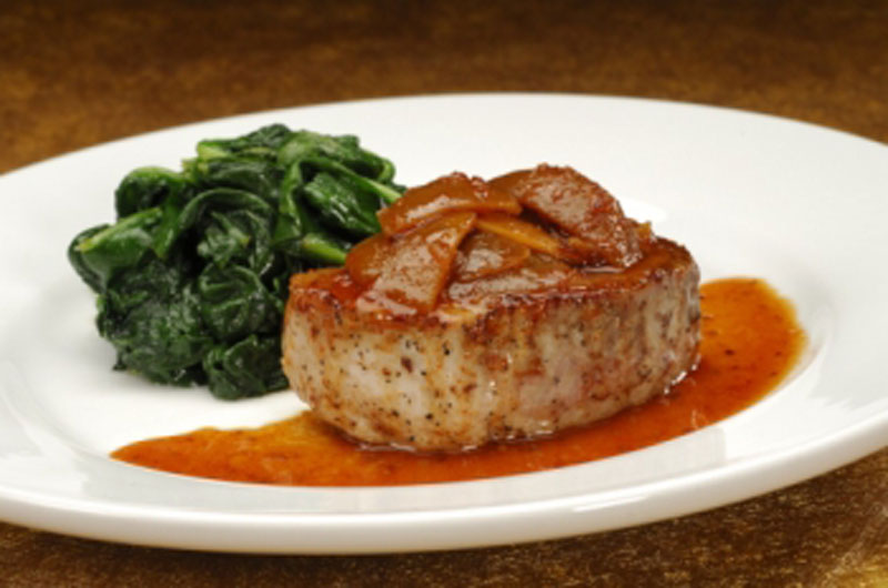Grilled Pork Chop Loin, glazed with pickled lime and ginger served with sauteed spinach