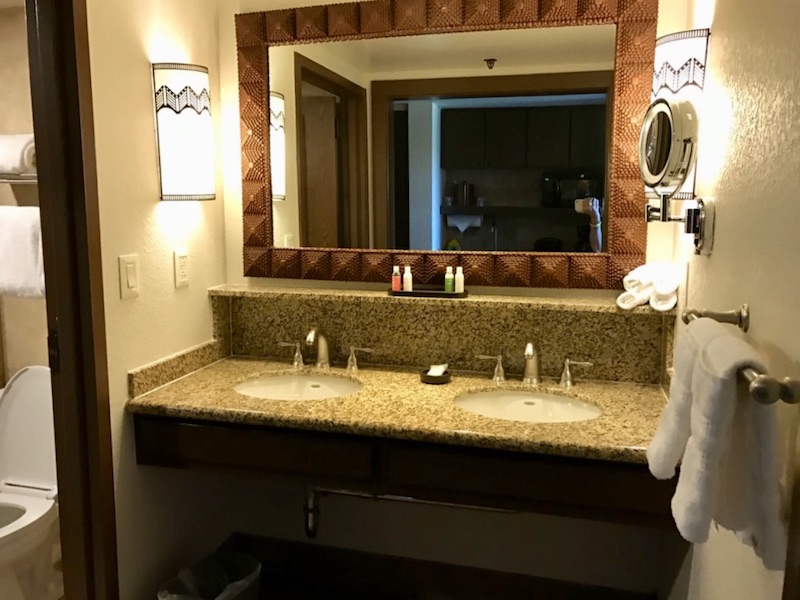 Vanity with bathroom to right