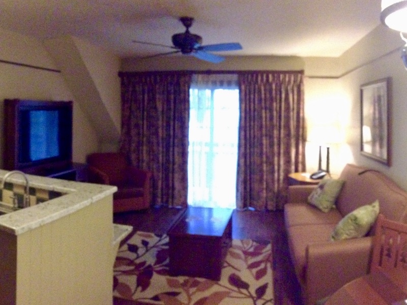 Living room with full size sofa bed, coffee table and flat panel TV